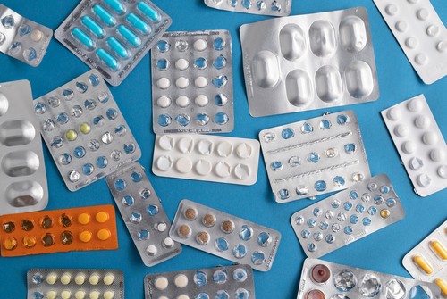 Pharmaceutical pill packs against a green background