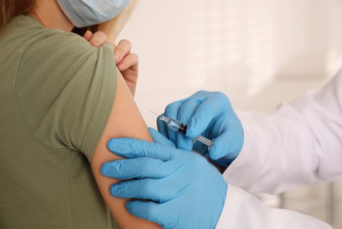 Young woman being vaccinated